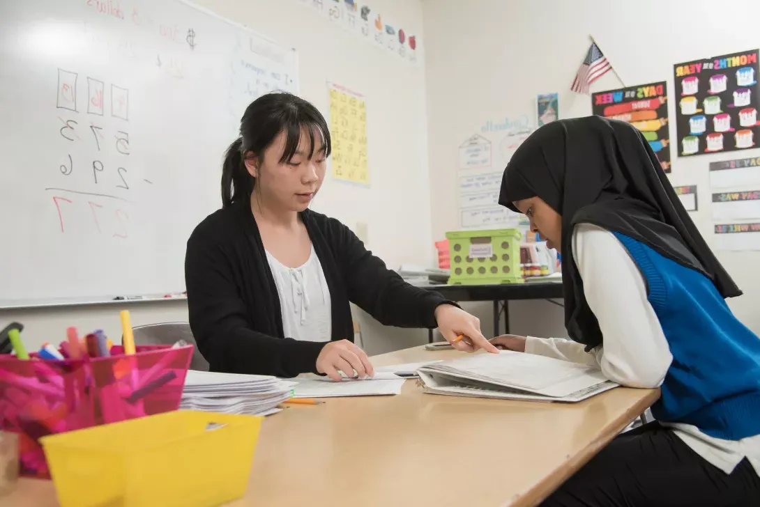 Student teacher working with a student in the classroom